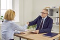 Serious senior lawyer, estate agent, broker or business advisor shakes hands with a client Royalty Free Stock Photo