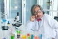 Serious senior male supervisor researchers and experiment working in life science laboratory