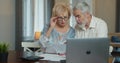 Serious senior old couple talking disputing holding paper bills checking finances expenses, older middle aged family Royalty Free Stock Photo