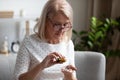 Elderly female pensioner having daily medicines at home