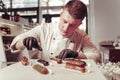 Serious skilled pastry chef focusing on his work