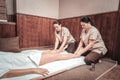 Serious skilled women performing massage for legs