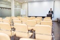 Serious speaker using laptop in empty boardroom Royalty Free Stock Photo