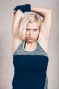 Serious sporty fitness woman stretching arms