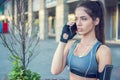 Serious sporty girl talking on mobile phone outdoors Royalty Free Stock Photo