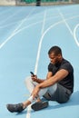 Serious sporty guy sending message, sms to his friends Royalty Free Stock Photo