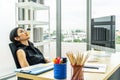 Serious stressed business woman sitting sad and thinking hard how to solve problem in office company bankruptcy