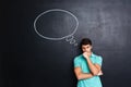 Serious stressed young man thinking over chalkboard background Royalty Free Stock Photo