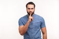 Serious strict bearded man holding finger near lips, showing shh gesture asking to keep silence and be quite, privacy Royalty Free Stock Photo