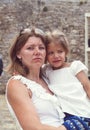A serious and strict mother holds an alarmed girl looking into t Royalty Free Stock Photo