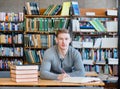 Serious student in a library looking at camera