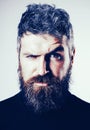 Serious stylish bearded man. Handsome young man isolated. Close up portrait of severe hot bearded guy with stylish