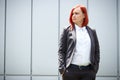 Serious successful red-haired girl boss, businesswoman in suit,