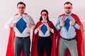 serious super businesspeople in masks and capes showing blue shirts Royalty Free Stock Photo