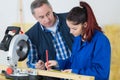 Serious supervisor talking to female apprentice carpenter Royalty Free Stock Photo