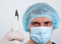 Serious surgeon with knife