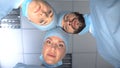 Serious surgeon team faces looking at patient waking up after coma, monitoring Royalty Free Stock Photo