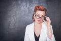 Serious teacher in glasses on blackboard background Royalty Free Stock Photo