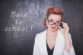 Serious teacher in glasses on blackboard background Royalty Free Stock Photo