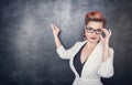 Serious teacher in glasses on the blackboard background Royalty Free Stock Photo