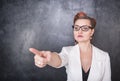 Serious teacher pointing out on chalkboard background Royalty Free Stock Photo