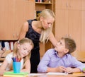 Serious teacher talking with a student during the exam Royalty Free Stock Photo