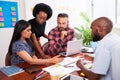 Serious team of developers brainstorming new app idea in boardroom meeting