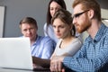 Serious team leader explaining online data on laptop to colleagu Royalty Free Stock Photo