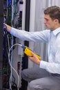 Serious technician using digital cable analyzer on server Royalty Free Stock Photo