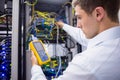 Serious technician using digital cable analyzer on server Royalty Free Stock Photo