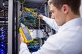 Serious technician using digital cable analyzer on server Royalty Free Stock Photo