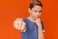 Serious teen boy training box punch, focus on fist Royalty Free Stock Photo