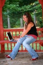 Teen Girl with Laptop on Bench Royalty Free Stock Photo