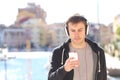 Serious teen listening to music in the street