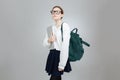 Serious teenage girl in glasses with backpack holding laptop Royalty Free Stock Photo