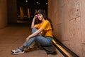 A serious teenage girl sits on a skateboard, posing on a night street. Outdoor. The concept of youth subculture Royalty Free Stock Photo