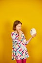 Serious teenager girl holding Ostrich egg with funny face Royalty Free Stock Photo