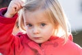 Serious thinking or sad young baby caucasian blonde real people girl close portrait outdoor Royalty Free Stock Photo