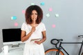 Serious thinking young african woman holding pencil. Royalty Free Stock Photo