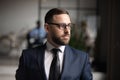 Serious thoughtful businessman wear suit looking away thinking of future