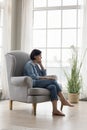 Serious thoughtful lonely mature lady sitting in armchair at home Royalty Free Stock Photo