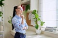 Serious thoughtful woman in her 30s looking out the window Royalty Free Stock Photo