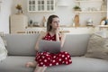 Serious thoughtful young freelancer girl working with laptop