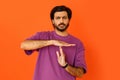 Serious tired indian man showing timeout symbol with hands Royalty Free Stock Photo