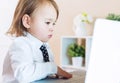 Serious toddler girl using her laptop Royalty Free Stock Photo