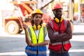 Serious two African american male and female worker checking control loading freight containers from Cargo freight ship for import