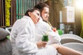 Serious unshaven man taking umbrage at girlfriend in the resort