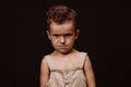 serious upset boy in overalls with a stylish hairstyle Royalty Free Stock Photo