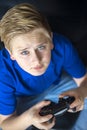 Serious video game playing teen looking up