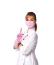 Serious woman doctor in white robe, pink disposable mask and gloves looking at camera pointing finger up. Royalty Free Stock Photo